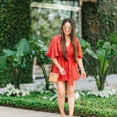 Summer essentials featured by top US fashion blog, LuxMommy: image of a woman wearing a Jack floral romper, Treasure & Bond wedge sandals, Antik Kraft straw bag, Quay Australia aviator sunglasses, Michele diamond watch, David Yurman bracelet, Argento Vivo necklace and Gorjana hoop earrings.